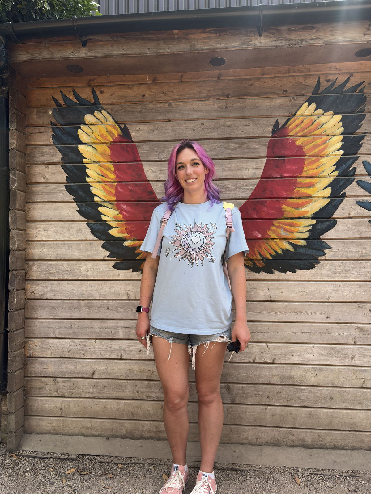 Lara Bailey, Fitness and Wellness Coach with rainbow hair smiling
